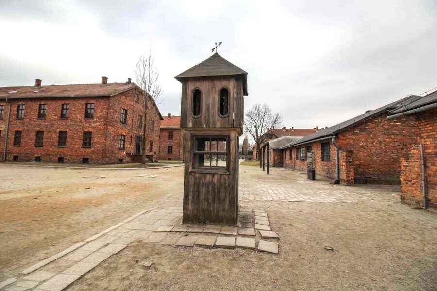 From Krakow: Guided Auschwitz-Birkenau Group Tour by Minivan - Stop 1, Auschwitz I: the main gate, barracks, watchtower, and the Death Wall