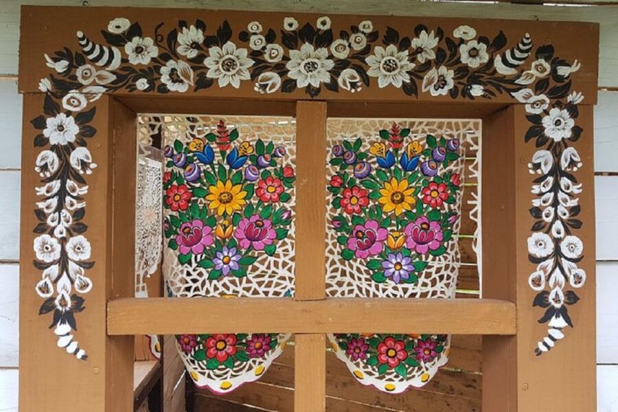 From Krakow: Zalipie and Painted Village Guided Tour - Folk art on display: walls, stoves, paper flowers, and cut designs